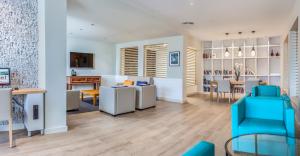 a living room and dining room with a blue chair at HG Lomo Blanco in Puerto del Carmen