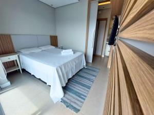 a bedroom with a bed and a flat screen tv at Book Santos - Unlimited 2111 Vista Mar in Santos