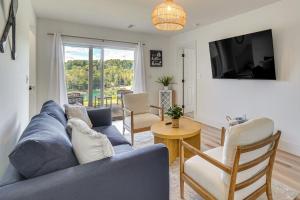 a living room with a blue couch and a tv at Private Boat Slip, Scenic Views Norris Lake Condo in Alder