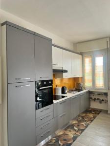 a white kitchen with white cabinets and appliances at TheSun in Legnano