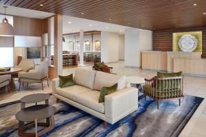 a living room with a couch and a table at Fairfield Inn & Suites Weldon in Weldon