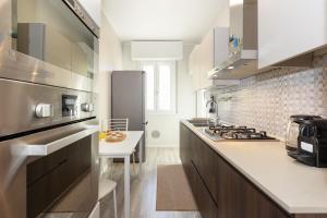 a kitchen with a stove and a counter top at Maison Prince Milano in Milan