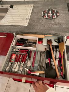 a drawer full of kitchen utensils in a kitchen counter at Au cœur de la perle du jura in Champagnole +16 photos
