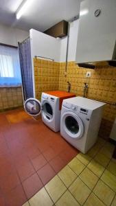 a kitchen with a washing machine and a washer at Casa Camelia in Intragna
