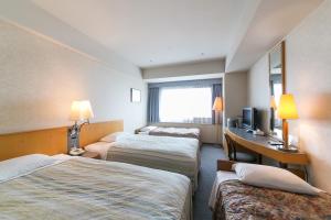 Postel nebo postele na pokoji v ubytování Yokohama Techno Tower Hotel