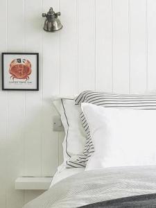 a bedroom with a bed and a picture of a crab at Shrimp Cromer in Cromer