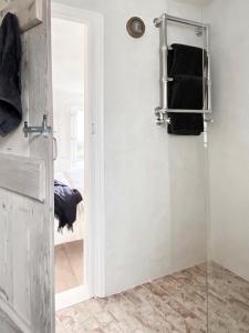 a bathroom with a shower and a door with towels at Shrimp Cromer in Cromer +48 photos