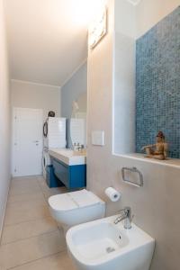 a bathroom with a white toilet and a sink at Maison Prince Milano in Milan +16 photos