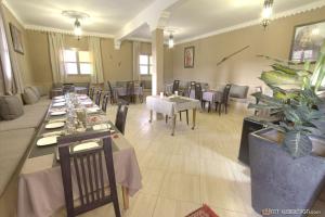 a restaurant with tables and chairs in a room at Guest House Bagdad Café in Aït Ben Haddou +63 photos