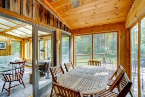a dining room with a wooden table and chairs at Secluded Family Getaway with On-Site Creek in Hawley in Hawley