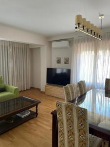 a living room with a glass table and a television at Quintanar Jaca in Jaca