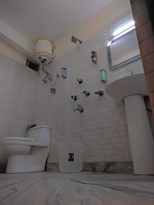 a bathroom with a toilet and a sink at The Valley Vista Resort Gangtok with Mountain View in Gangtok