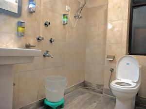 a bathroom with a toilet and a sink at The Valley Vista Resort Gangtok with Mountain View in Gangtok +12 photos