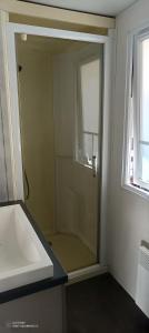 un baño con ducha y lavabo en Mobilhome - La Palmyre Camping, en La Palmyre