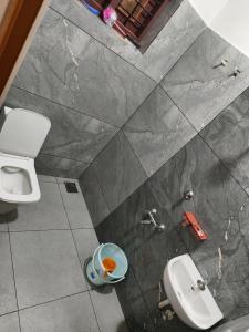 a bathroom with a toilet and a sink at White Shadow in Varkala +10 photos