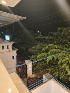 a view from the balcony of a building with a tree at White Shadow in Varkala