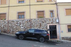 a black car parked in front of a building at Atardecer dorado in Ruidera