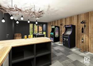 a room with two arcade games and a bar with a counter at Les 4 Fontaines in Osenbach