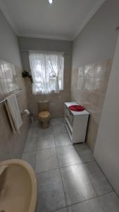 a bathroom with a tub and a sink and a toilet at Amarachi Guesthouse in Swakopmund +111 photos