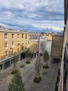 a view of a city with trees and buildings at T3 Le logis de Martin - city center - near Ducale Place with parking space in Charleville-Mézières