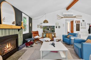 a living room with a fireplace and blue furniture at Family Cabin w Fireplace Fire Pit Grill Trail Access in Baxter +48 photos