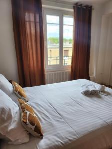 a bedroom with a bed with two pairs of glasses on it at T3 Le logis de Martin - city center - near Ducale Place with parking space in Charleville-Mézières