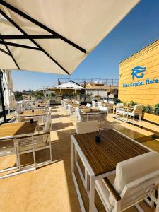 a patio with tables and chairs and a building at Giza Capital Hotel in Cairo