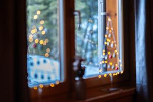 a window with christmas lights in a room at Edelweiss Lodge Lachtal I Self Check-in in Lachtal