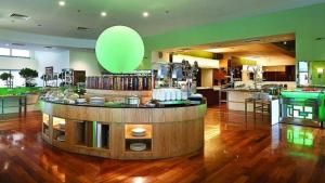 a large room with a bar with a green balloon at Signature Apartment Berjaya Times square Bukit Bintang in Kuala Lumpur