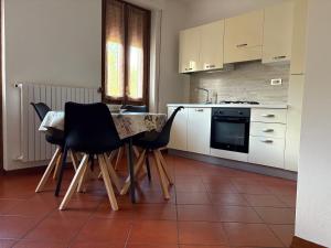 a kitchen with a table and chairs in a room at Home Sweet Home Affittacamere - Lucca in Lucca +38 photos