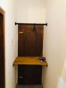 a wooden door in a room with a pair of scissors at Melon Guest - Weligama in Weligama