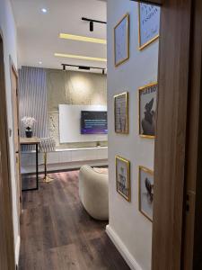 a hallway with a living room with a wall with pictures at AmandaHome in Lekki