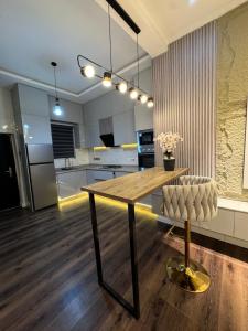 a kitchen with a wooden table and a chair at AmandaHome in Lekki