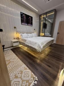 a bedroom with a large bed and a mirror at AmandaHome in Lekki