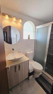 a bathroom with a toilet and a sink and a shower at departamento frete al mar in Manzanillo +20 photos