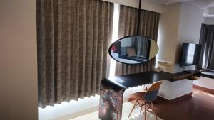 a room with a desk with a mirror and a mirror at Ruby Apartment #35 in Kejayan