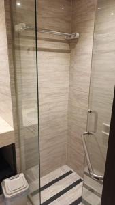 a bathroom with a shower and a toilet at Ruby Apartment #35 in Kejayan +1 photo