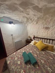 a bedroom with a bed with two pillows on it at La casita del Cerro in Chinchilla de Monte Aragón