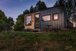 a tiny house sitting on top of a field at Cabañas en el bosque cerca de Barcelona in Talamanca +2 photos