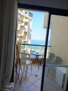 a balcony with a table and chairs and a view of the ocean at סיוטה נוף לכינרת in Tiberias