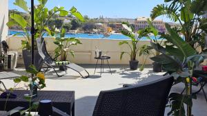 a balcony with plants and a view of a harbor at Aime's House in Sliema