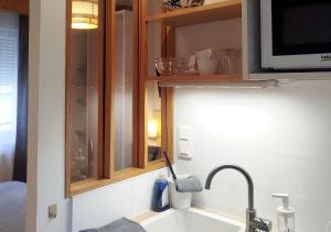 a kitchen counter with a sink and a microwave at Studio à la VILLA VOLTAIRE in Clamart +32 photos