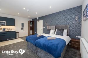 a bedroom with a king sized bed and a tv at Eden Bay Serviced Apartments - Eden in Morecambe
