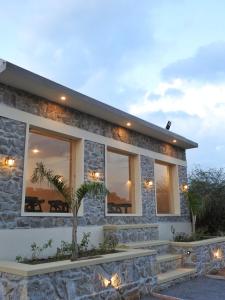 a stone house with a palm tree in front of it at Jawai-e-khaas in Bijāpur