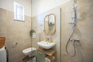 a bathroom with a sink and a shower with a mirror at Atelier LAKOTA in Brtonigla +27 photos