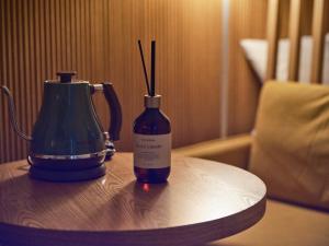a bottle of wine and a blender on a table at Hotel Stayre in Incheon