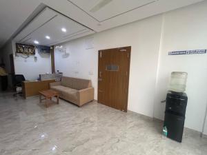 a living room with a couch and a door at Hotel O Jodi Sri Muneshwara Swamy Temple in Jālahalli