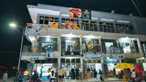 a building with people standing outside of it at night at montana restaurant musanze in Ruhengeri