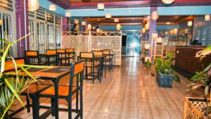 a row of tables and chairs in a restaurant at montana restaurant musanze in Ruhengeri