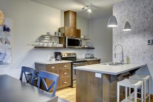 a kitchen with a sink and a stove top oven at RCNT Chalets Mont-Tremblant in Lac-Superieur